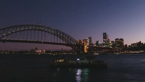 Sydney Harbour bridge - Tracking Ferry at magic hour pink sky - Drone Aerial Stock Footage 235164334