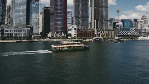 Sydney Harbour Tracking ferry through Barangaroo up to buildings -Drone Aerial Stock Footage 234984569