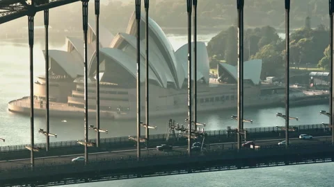 Sydney Opera House framed by Sydney Harbour Bridge at sunrise 動画素材 319307679