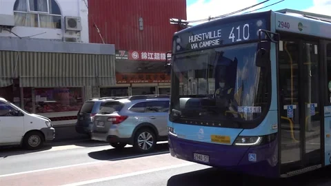Sydney public bus driving through a busy suburban street Stock Footage 219728945