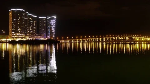 Syline Macau at Night with reflections of Mandarin Oriental Casino and Bridge. Stock Footage 82856320
