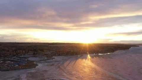 Sylvan Lake sunset over the spring ice with light house Stock Footage 130080671