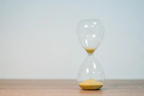 Symbol of close deadline, countdown, ending time on sand timer Stock Photos