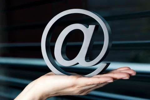 At-symbol held in hand. Stock Photos