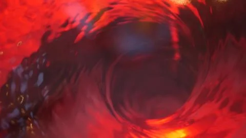 Symbol of hell, inferno and infinity. Red liquid hypnotic aqua swirl turning. Stock Photos