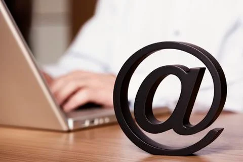 At symbol with laptop. Stock Photos
