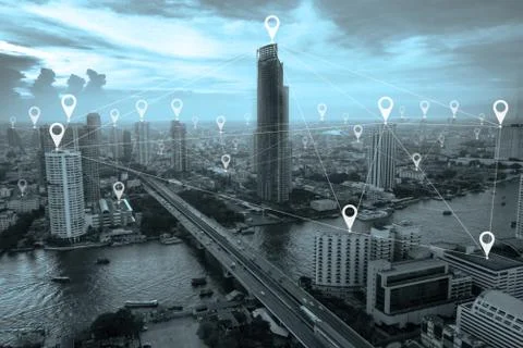 Symbol map pin and network for searching location above city scape with blue  Stock Photos
