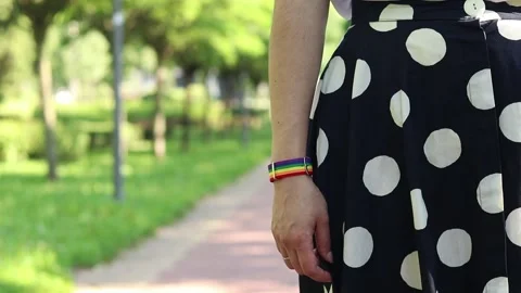 Symbol of pride and support. Hand with rainbow bracelet outdoors Видео 339634522