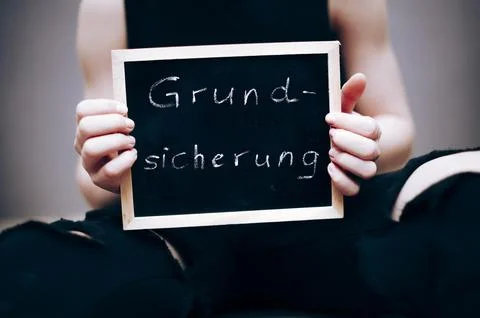 Symbolic image Child basic security child poverty child in torn clothes holds Stock Photos