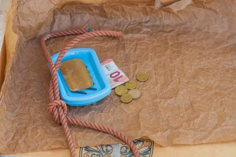 Symbolic scene, solid soap, gallows loop, euro coins, 10 euro banknote. Hopeless Stock Photos