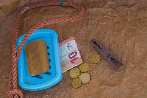 Symbolic scene, solid soap, gallows loop, euro coins, 10 euro banknote, clo.. Stock Photos