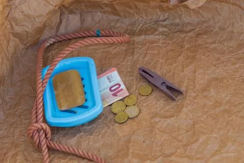 Symbolic scene, solid soap, gallows loop, euro coins, 10 euro banknote, money Stock Photos