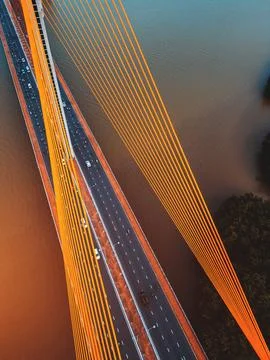 Symmetric modern cable-stayed bridge over rive, Contemporary urban span con.. Stock Photos
