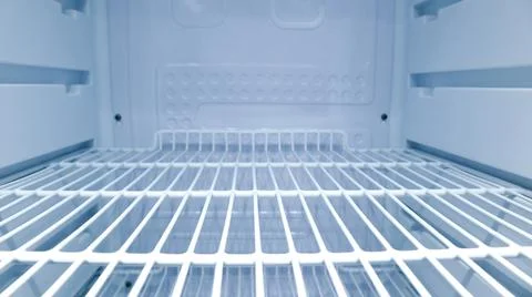 Symmetrical internal view looking straight inside an empty clean refrigerat.. Stock Photos