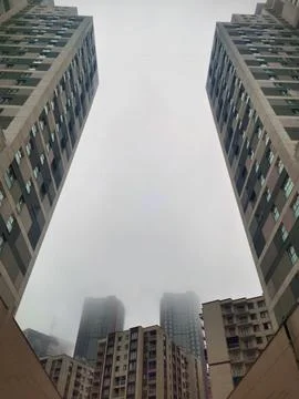 Symmetrical low angle shot looking straight up between tall modern apartment Stock Photos