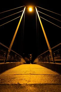 Symmetrical night scene of a cable-stayed bridge with cables forming guide lines Stock Photos
