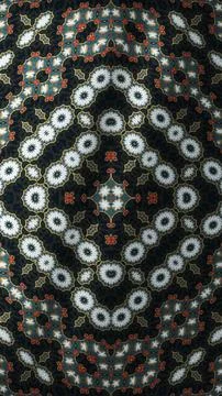 Symmetrical ornate mandala pattern featuring dark multi colored elements. Stock Illustration