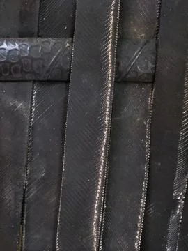 Symmetrical pattern and texture of rubber tires arranged in a row Stock Photos