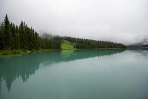 Symmetrical picture of the trees reflected on the surface of Emerald lake. Stock Photos