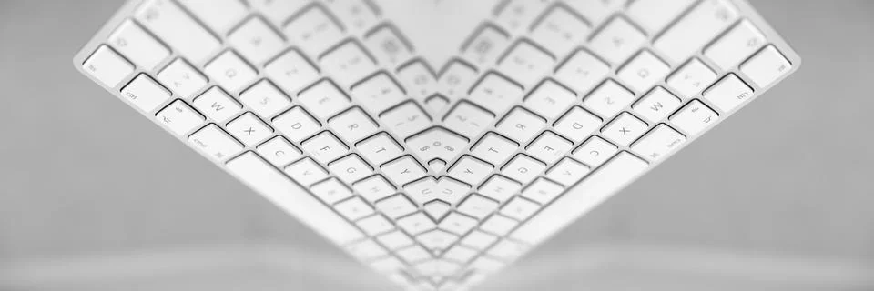 Symmetrical reflection of white computer keyboard. Abstract background. 写真素材