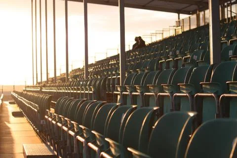 Symmetrical regular pattern grandstand seating arrangement at sunset Stock Photos