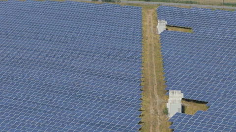 Symmetrical Rows Of Blue Solar Panels And Large Battery Storage Containers .. Stock Footage 338992229