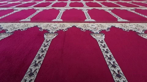 Symmetrical rows of red patterned prayer carpet inside mosque Stock-Footage 342582429