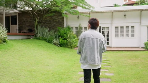 A symmetrical shot of a man in a jean jacket walking gracefully in a Video stock 249593156