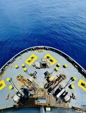 Symmetrical View of Container Ship Bow Cutting Through Calm Blue Ocean Stock Photos