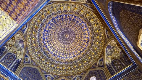 Symmetrical view of the golden interior dome in Tilya-Kori Mosque Stock Footage 336913566