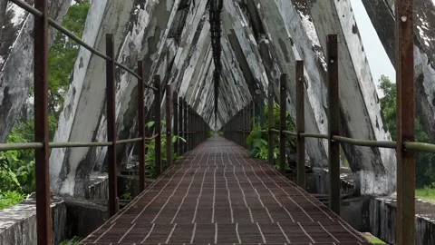 Symmetrical walkway inside a geometric concrete bridge structure Видео 337928502