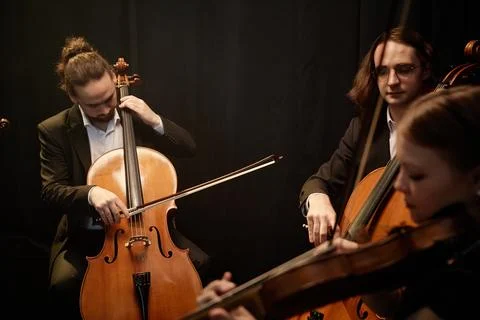 Symphonic Orchestra Musicians Playing Cellos and Violins at Concert Stock Photos