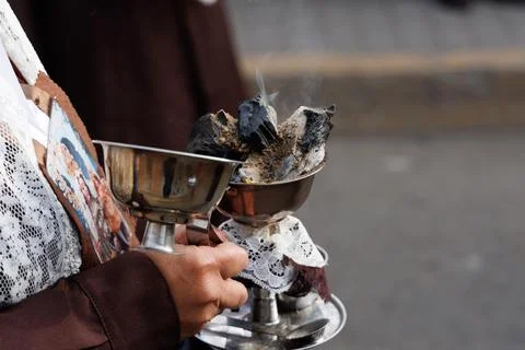 A Symphony of Incense and Devotion. Their hands holding incense burners Stock Photos