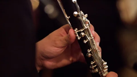 Symphony orchestra player is playing clarinette during the symphonic concert Stock Footage 92775197