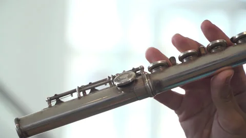 Symphony orchestra player is playing flute during the symphonic concert Stock-Footage 134695080