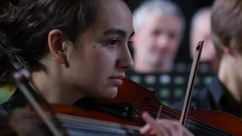 Symphony Orchestra violinist playing on the stage of a classical theater. Stock Footage 277827664