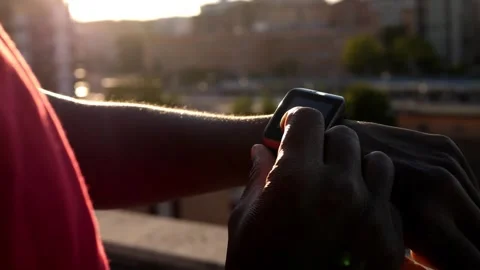 Synchronization, device-hand of black man scrolls the keyboard of the smartwatch Stock Footage 240323470