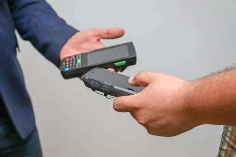 Synchronize Data Devices Two Man Sharing Handheld Mobile Computers Data Co... Stock Photos