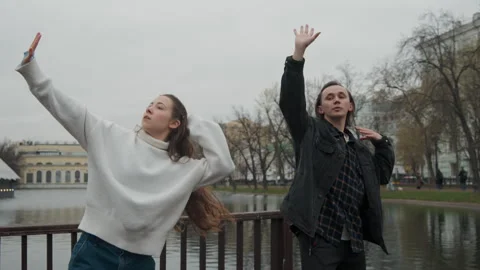Synchronized Dance Performance by Young Adults on Urban Bridge with Lake and Stock Footage 344877832