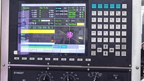 Syntec CNC machine control panel display showing active G-code and coordinates Stock Footage 337532920
