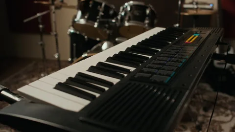 Synthesizer Keyboard Standing in Empty Music Rehearsal Studio Stock Footage 336378018