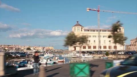Syracuse sicily italy driving on bridge with buildings next to it and people Stock-Footage 252155091