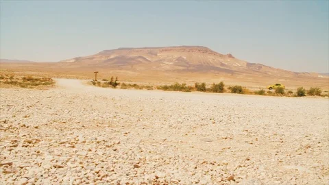 SYRIA:Car drives through frame in desert setting Stock Footage 88561134