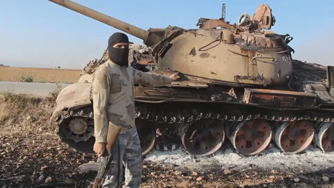 Syrian opposition rebels on the background of destroyed tanks Video stock 169239881