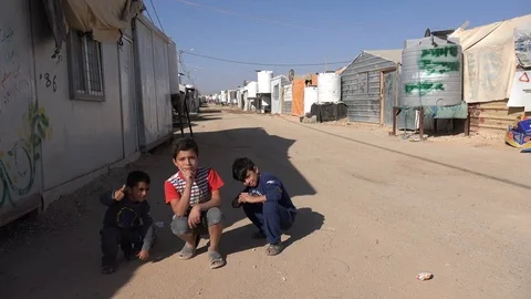Syrian refugee kids pose for the camera inside the Zaatari camp in Jordan Stock Footage 71528763