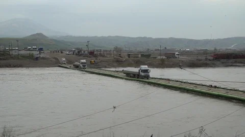 Syrian trucks crossing floating bridge 4 Stock Footage 104881279