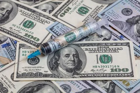 Syringe with 100 dollar banknote inside Stock Photos