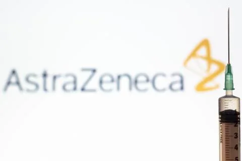 Syringe and AstraZeneca logo on the background. Coronavirus, Covid-19 vaccine Stock Photos