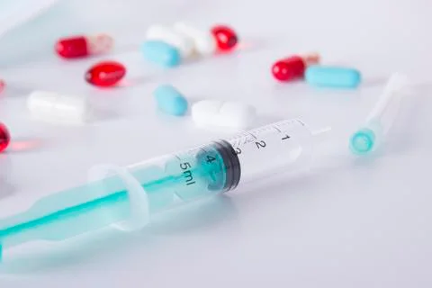Syringe and pill Stock Photos
