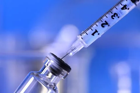 Syringe Being Inserted into a Vial Stock Photos